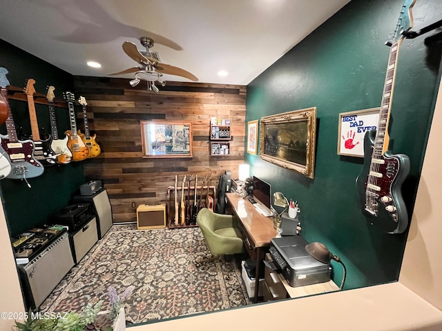 kitchen with ceiling fan and wood walls