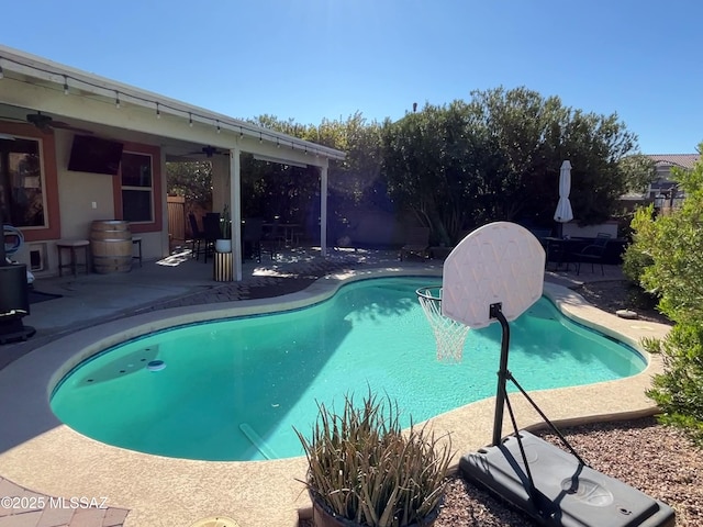 view of pool featuring ceiling fan and a patio area