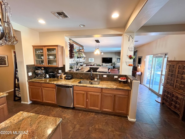 kitchen with decorative light fixtures, sink, light stone counters, dishwasher, and decorative backsplash