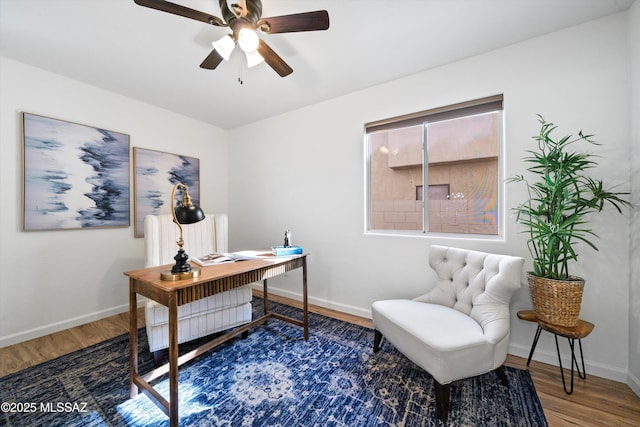 office area featuring dark wood-type flooring and ceiling fan