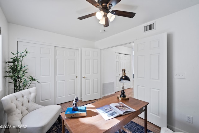 home office with ceiling fan and hardwood / wood-style floors