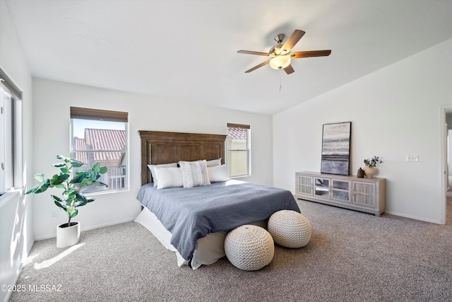 bedroom featuring ceiling fan, lofted ceiling, carpet floors, and multiple windows