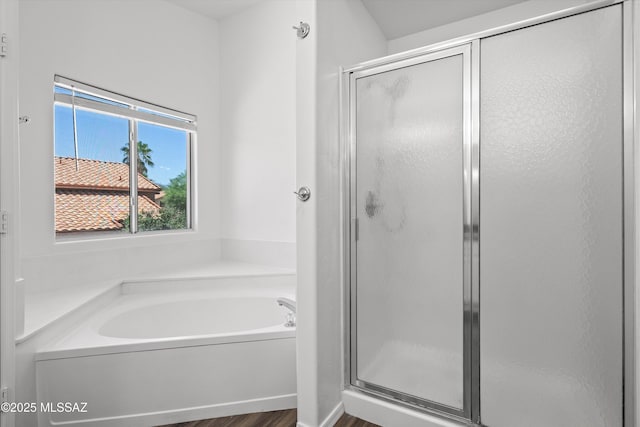 bathroom featuring separate shower and tub