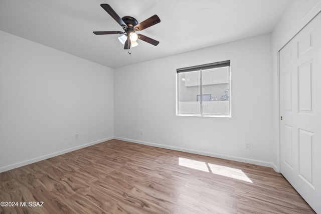 unfurnished bedroom with ceiling fan and light wood-type flooring