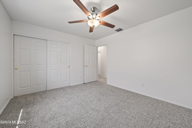 unfurnished bedroom featuring a closet, ceiling fan, and carpet flooring