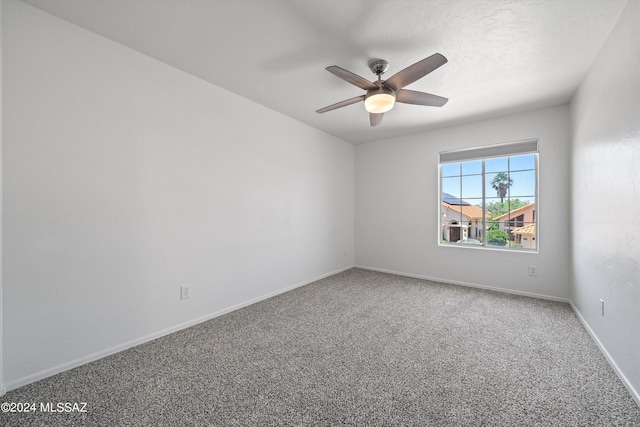 empty room featuring ceiling fan and carpet floors