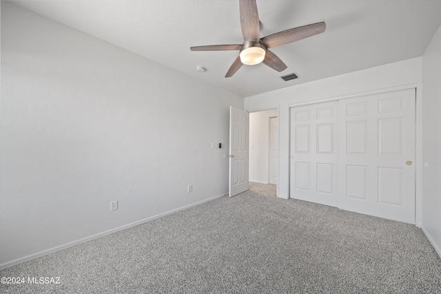 unfurnished bedroom with a closet, ceiling fan, and carpet flooring