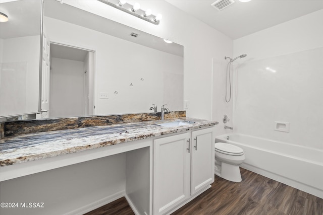 full bathroom with shower / bathing tub combination, hardwood / wood-style floors, vanity, and toilet