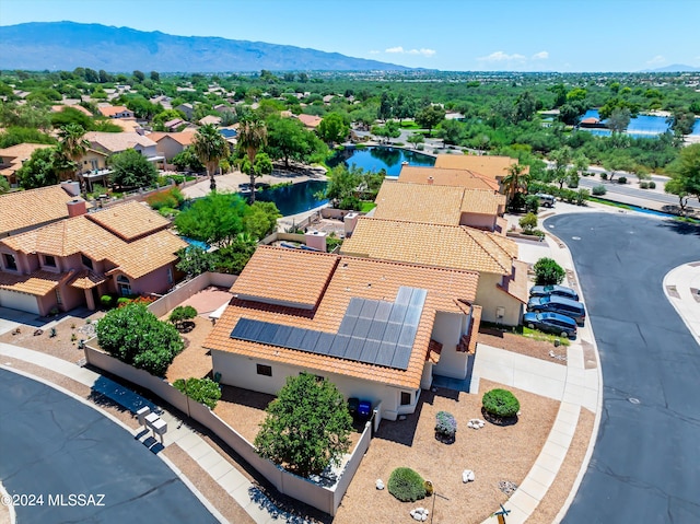 birds eye view of property featuring a water and mountain view