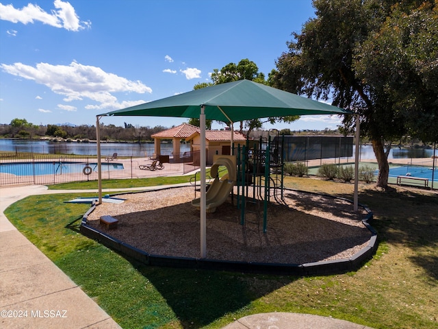 view of play area featuring a water view, a community pool, and a gazebo