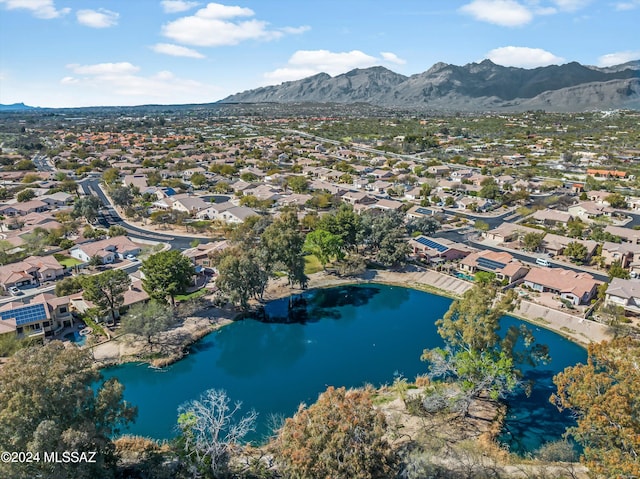 birds eye view of property with a water and mountain view