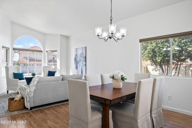 dining area featuring a notable chandelier, hardwood / wood-style flooring, and plenty of natural light