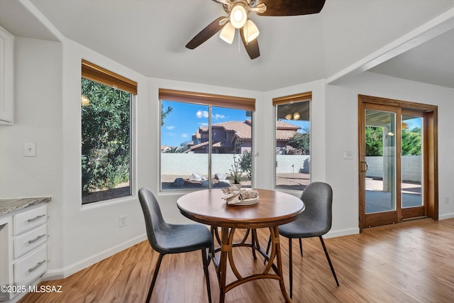 dining space with ceiling fan, light hardwood / wood-style flooring, and a healthy amount of sunlight