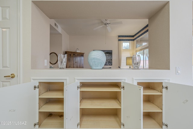 interior space with ceiling fan