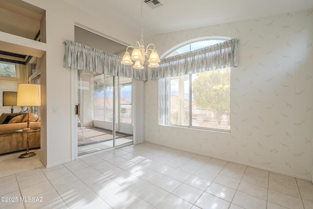 unfurnished dining area with tile patterned floors and a notable chandelier