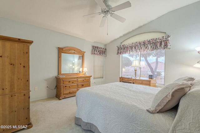 carpeted bedroom with ceiling fan and vaulted ceiling