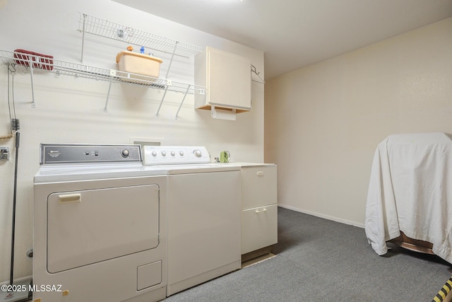 washroom with cabinets, washer and clothes dryer, and dark colored carpet