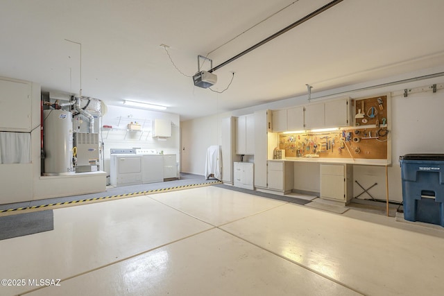 garage featuring a garage door opener, washing machine and dryer, and water heater