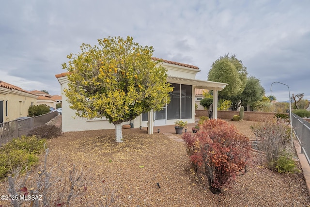 rear view of property with a sunroom