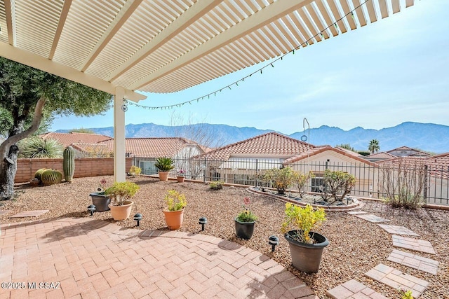 view of patio / terrace with a pergola and a mountain view