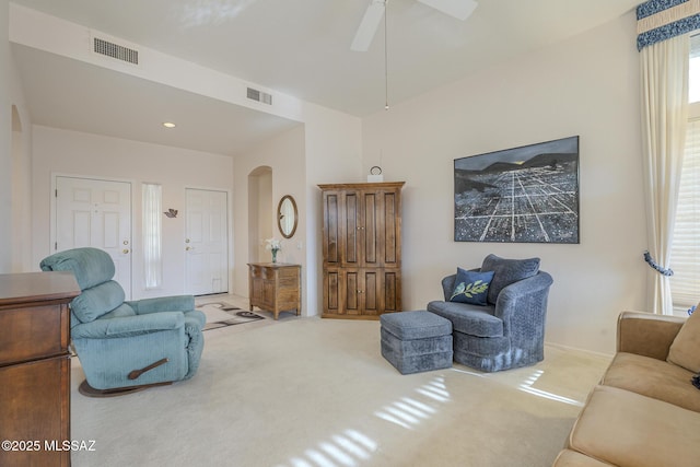 carpeted living room featuring ceiling fan