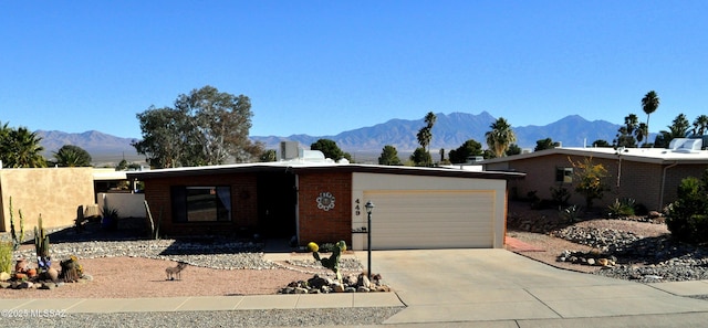 449 W San Ignacio, Green Valley, AZ 85614 - single story home featuring a garage, a mountain view, concrete driveway, and brick siding