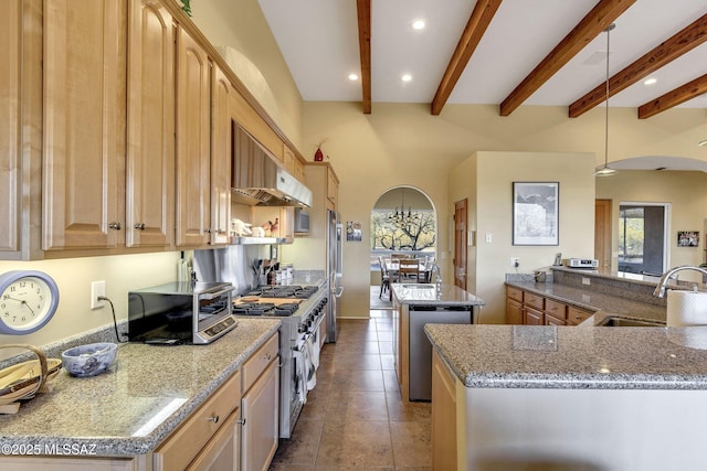 kitchen featuring a kitchen island, light brown cabinetry, sink, hanging light fixtures, and stainless steel appliances