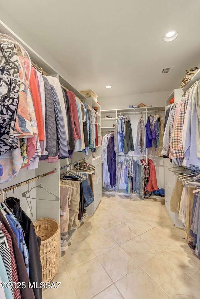 walk in closet featuring light tile patterned flooring