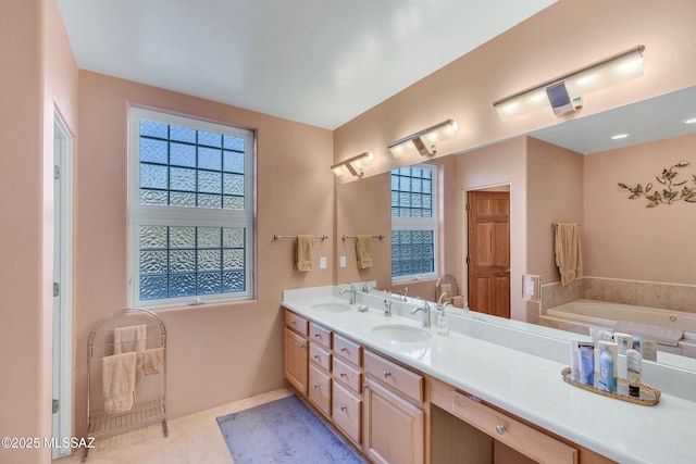 bathroom with tile patterned floors, vanity, and a bathing tub