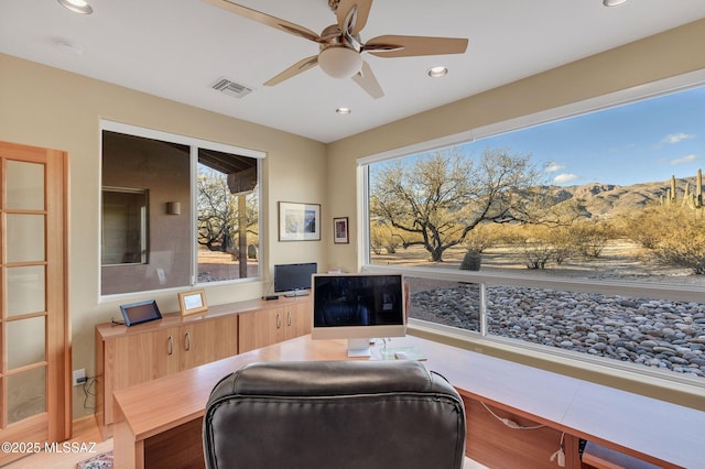 home office with ceiling fan and light hardwood / wood-style floors