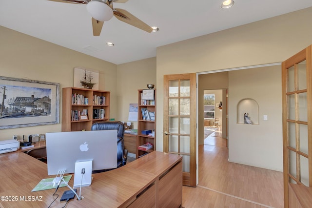 home office with light hardwood / wood-style flooring, french doors, and ceiling fan