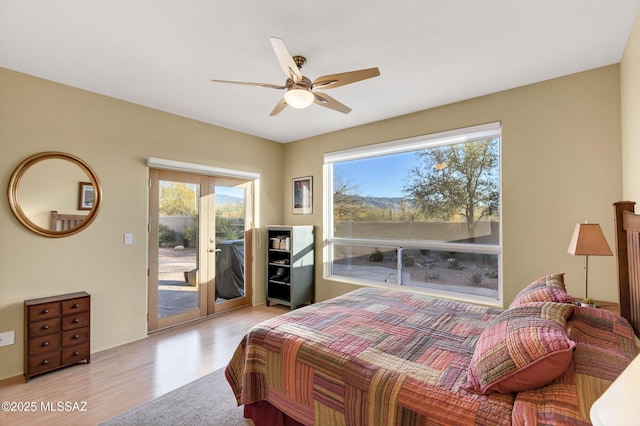 bedroom featuring ceiling fan, light hardwood / wood-style flooring, and access to outside