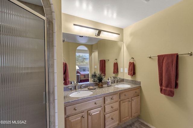 bathroom with a shower with door and vanity