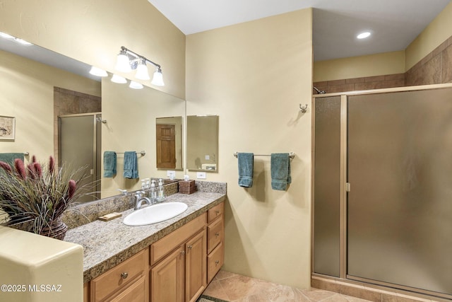 bathroom with vanity, tile patterned floors, and a shower with door