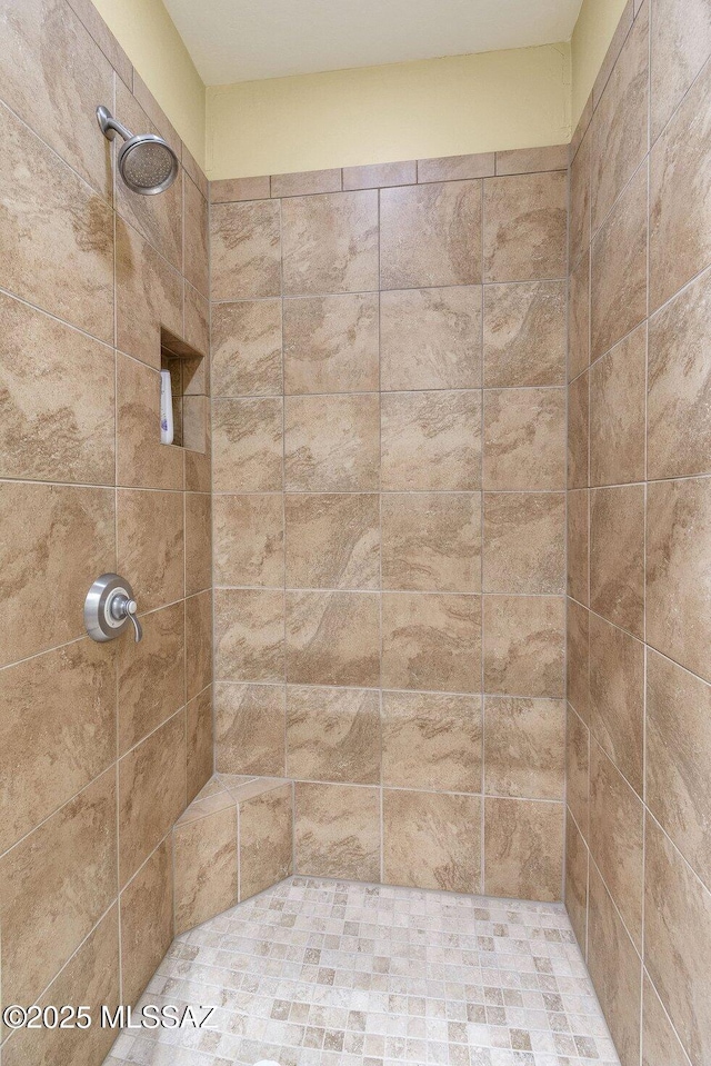 bathroom with tiled shower