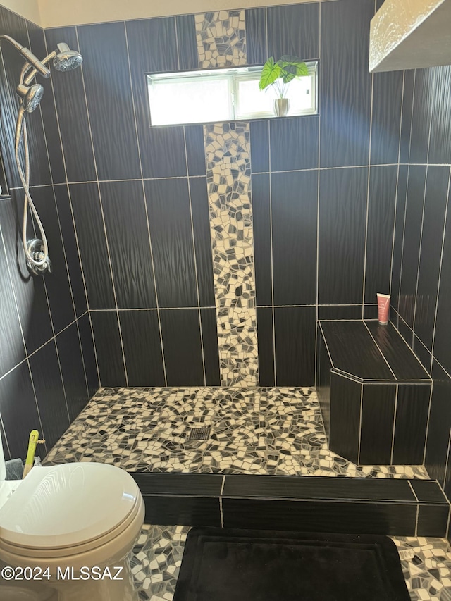 bathroom with toilet and tiled shower