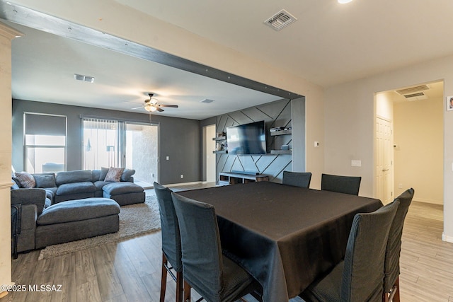 dining room with ceiling fan and light wood-type flooring