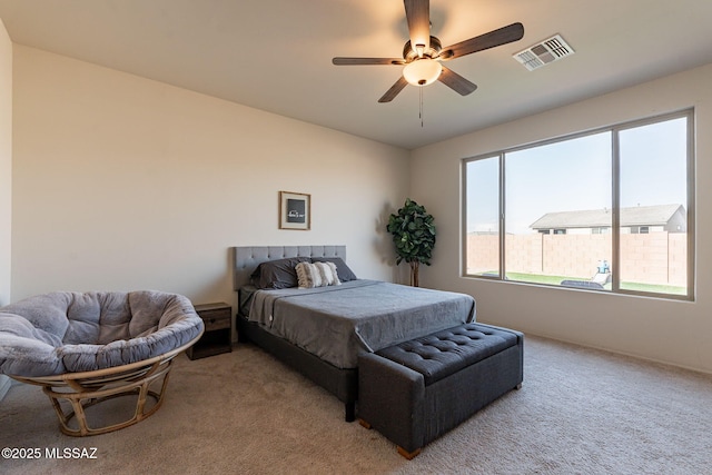 bedroom featuring ceiling fan, carpet, and multiple windows