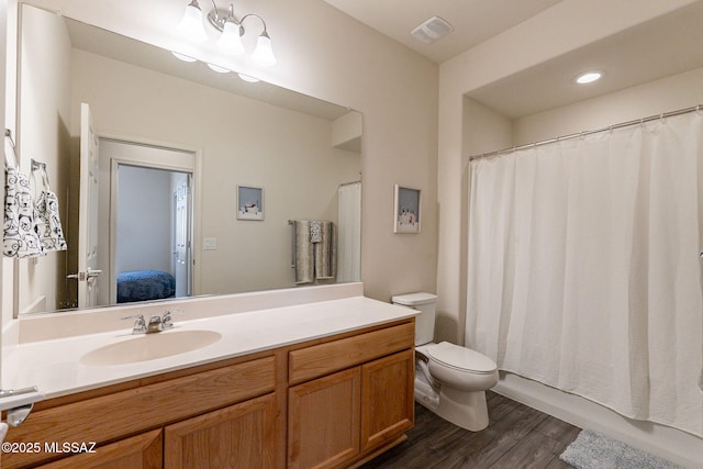 full bathroom featuring shower / tub combo, vanity, toilet, and hardwood / wood-style floors