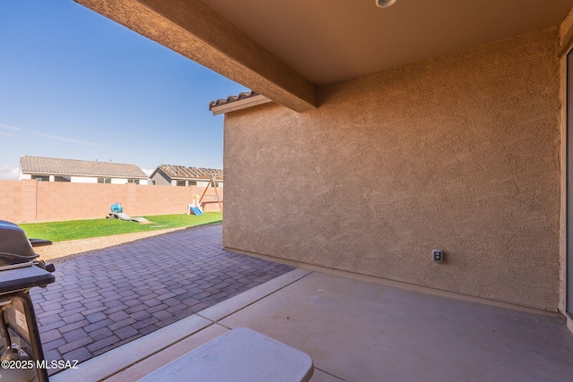 view of patio featuring area for grilling and a playground