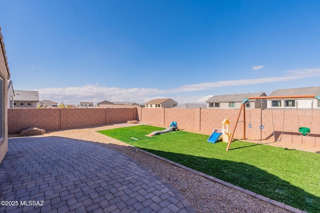 view of yard with a patio and a playground