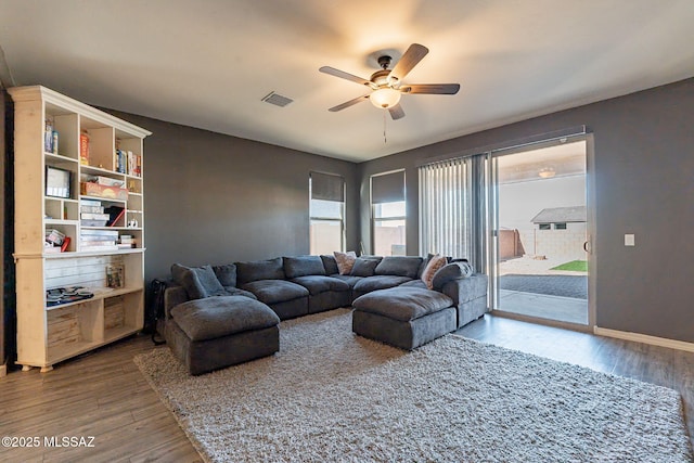 living room featuring hardwood / wood-style floors and ceiling fan