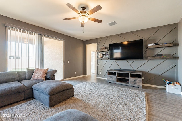 living room featuring hardwood / wood-style flooring and ceiling fan