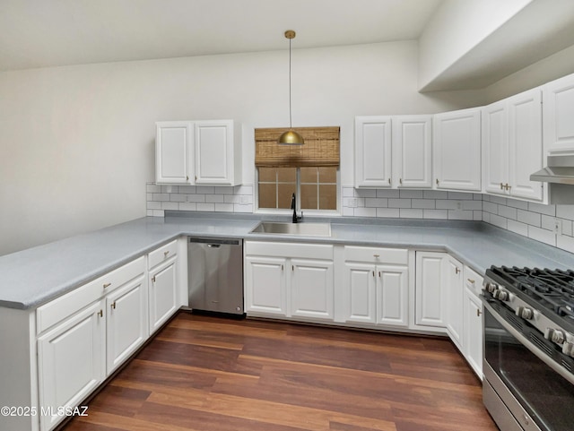 kitchen featuring pendant lighting, sink, appliances with stainless steel finishes, tasteful backsplash, and white cabinets