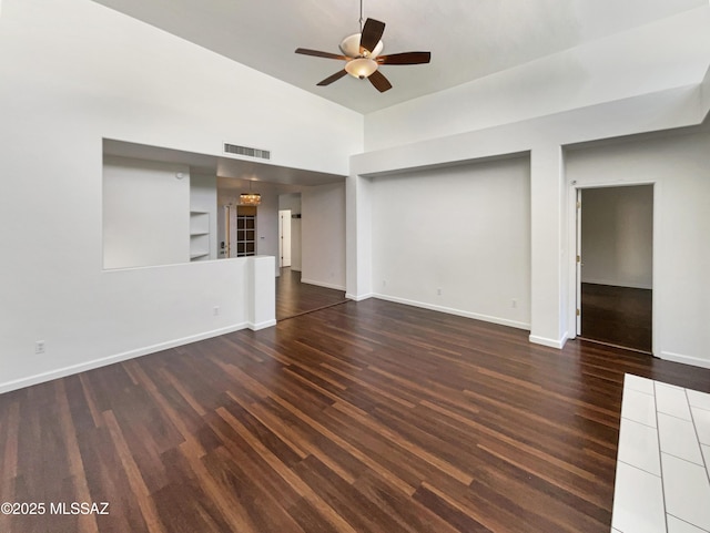 unfurnished living room with dark hardwood / wood-style flooring and ceiling fan