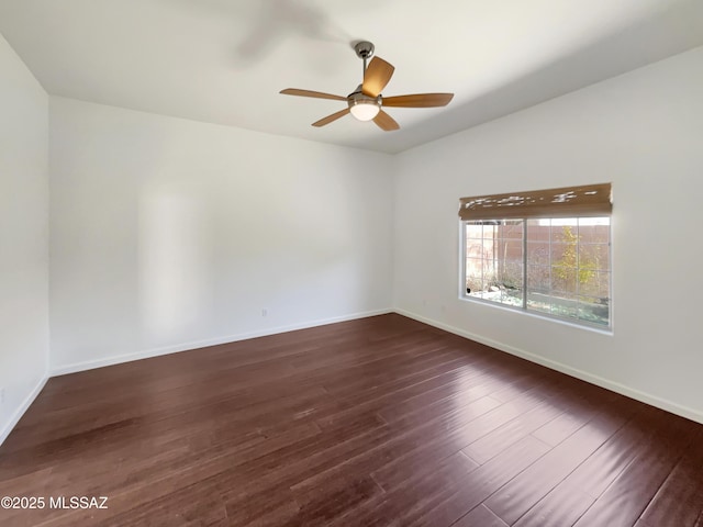 spare room with dark hardwood / wood-style floors and ceiling fan