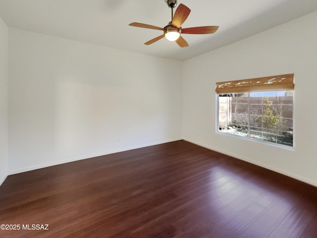 empty room featuring ceiling fan and dark hardwood / wood-style flooring