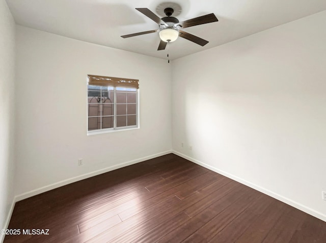 unfurnished room featuring dark wood-type flooring and ceiling fan