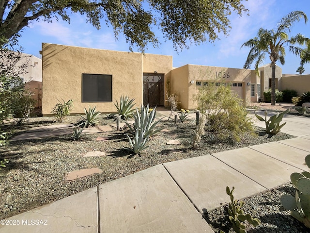 adobe home featuring a garage