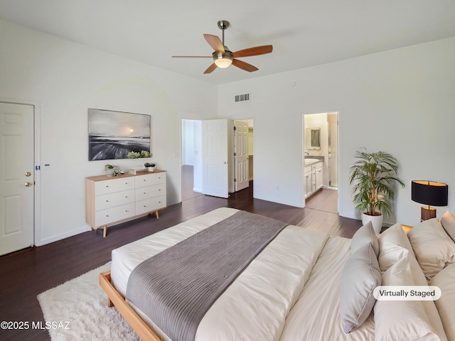 bedroom featuring dark wood-type flooring, ceiling fan, and ensuite bathroom